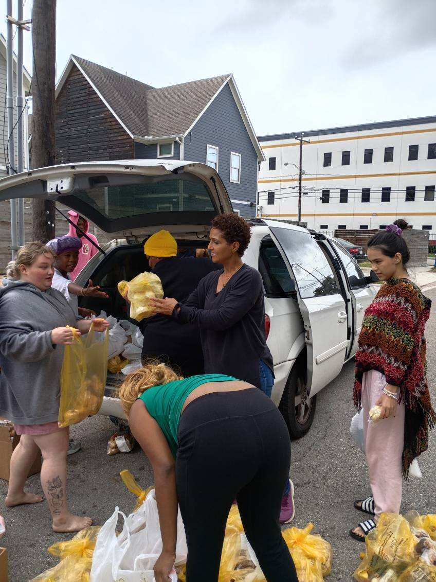 Volunteers loading donations from a vehicle