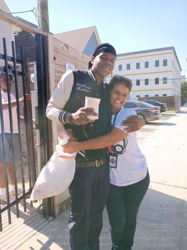 A volunteer embraces a neighbor during a food outreach in Houston